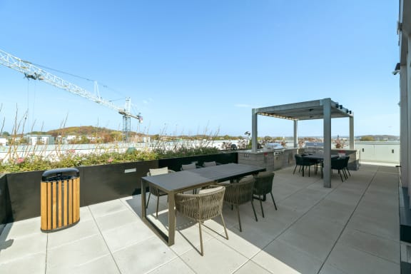 a roof terrace with tables and chairs and a pavilion  at Link Apartments® H Street, Washington