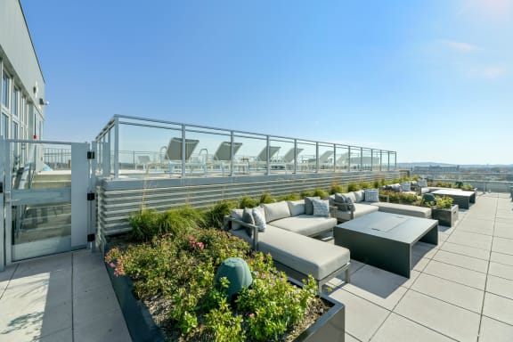 a terrace with couches and tables on a roof top  at Link Apartments® H Street, Washington, Washington