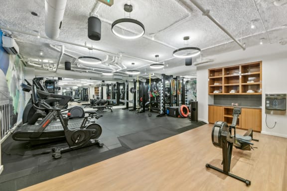 a gym with weights and other exercise equipment on a wooden floor  at Link Apartments® H Street, Washington