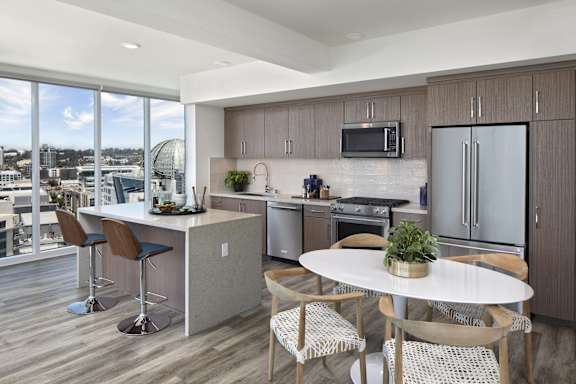 A modern kitchen with a dining table and chairs.