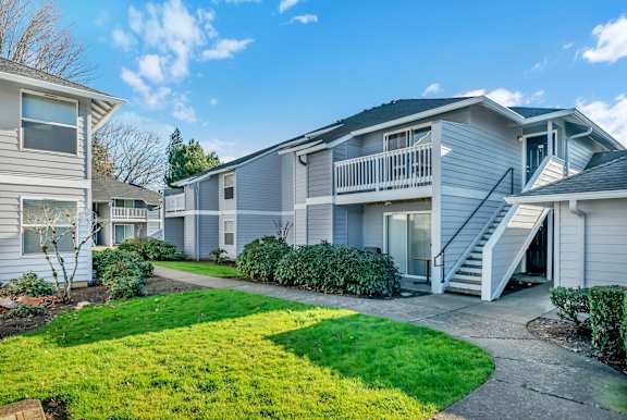 A sunny day at a residential area with houses and green lawns.