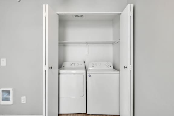 A white washer and dryer in a small laundry room.