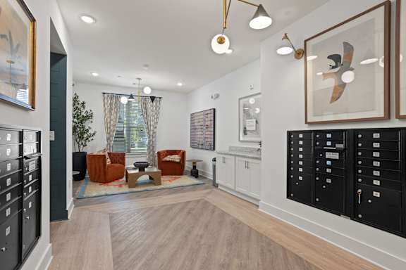 A modern living room with a wooden floor and white walls.