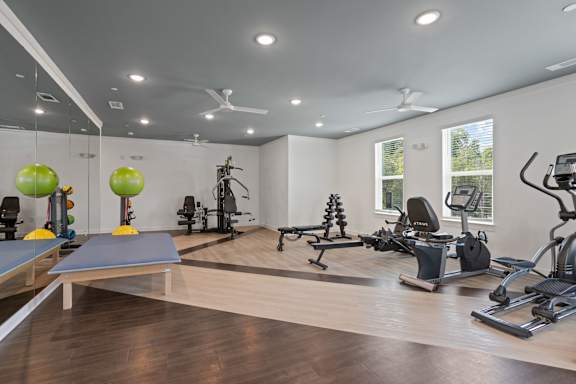 A spacious gym with a variety of exercise equipment.