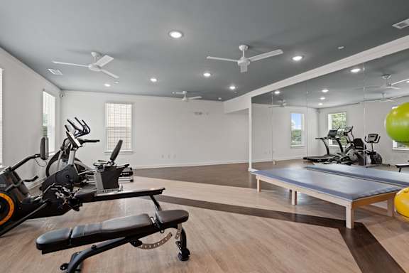 A spacious gym with a variety of exercise equipment.