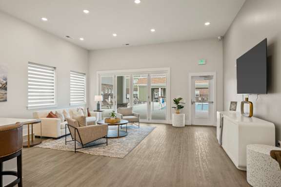 A modern living room with a wooden floor and white walls.