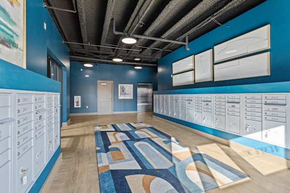 A room with a blue wall and a whiteboard on the wall.