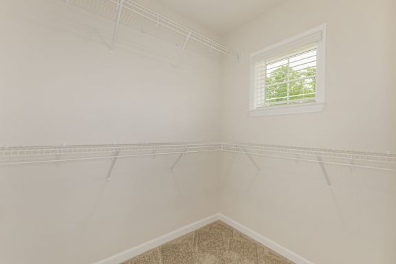 Walk-in closet with wire shelving and window at The Courts at Maverick Yards Apartments, Mauldin, SC 29662