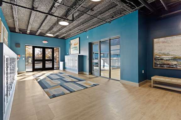 A room with a blue wall and a wooden floor.