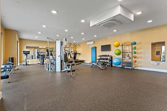 A spacious gym with a variety of exercise equipment.
