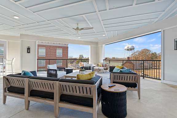 A patio with a sofa, table, and chairs.
