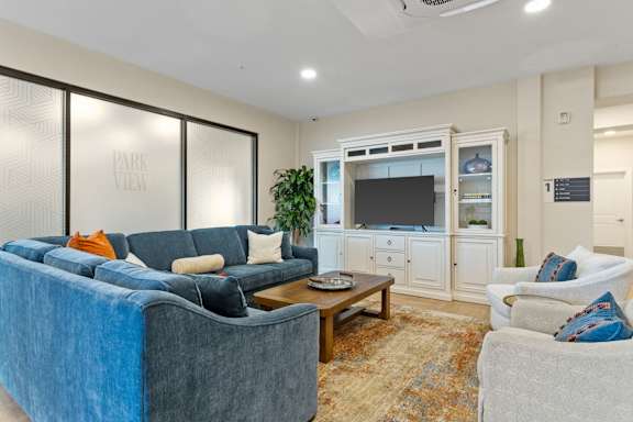 A living room with a blue couch and a television.