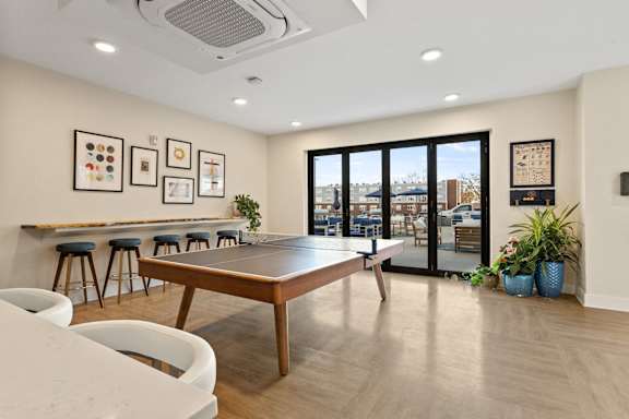 A modern dining room with a long table and chairs.