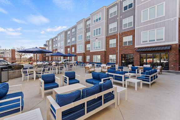 A patio area with blue and white furniture.