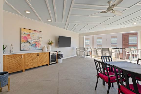 A room with a ceiling fan and a painting on the wall.