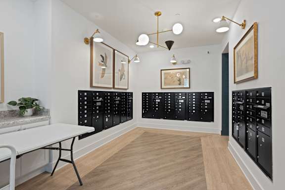 A room with a white table and black cabinets.