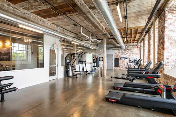 A gym with treadmills and exercise equipment.
