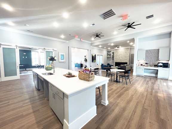an open kitchen and living room with a large island and a dining room table