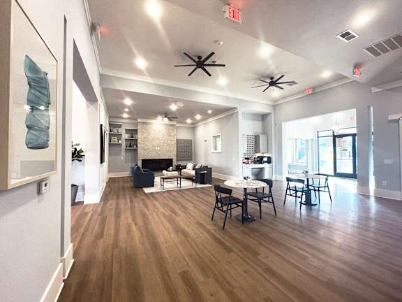 a large living room with a table and chairs and a fireplace