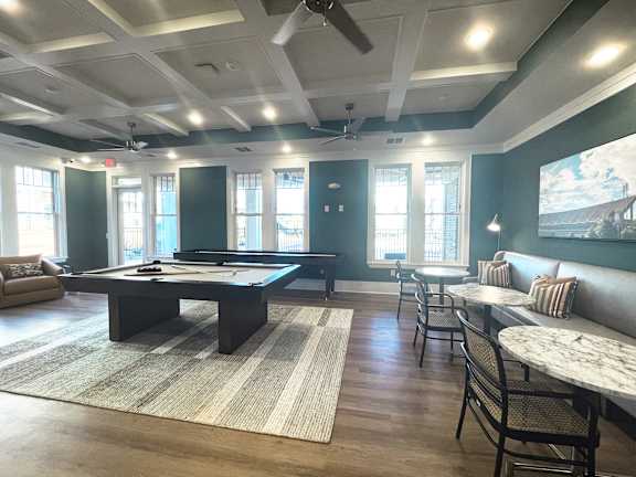 a game room with a pool table and a bar