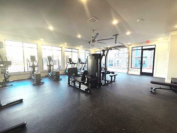 Falls at Meehan's State-of-the-Art Wellness Center with a leg press machine, a pull-up machine, three treadmills, two ellipticals, and a Peloton bike.