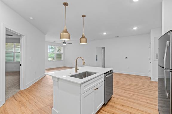 A kitchen with a white counter and a sink.