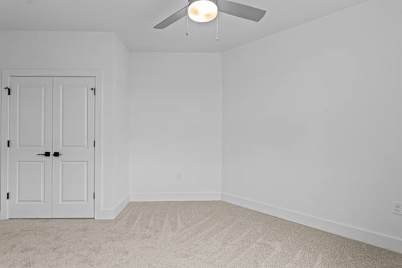 A white door is in a room with a ceiling fan.