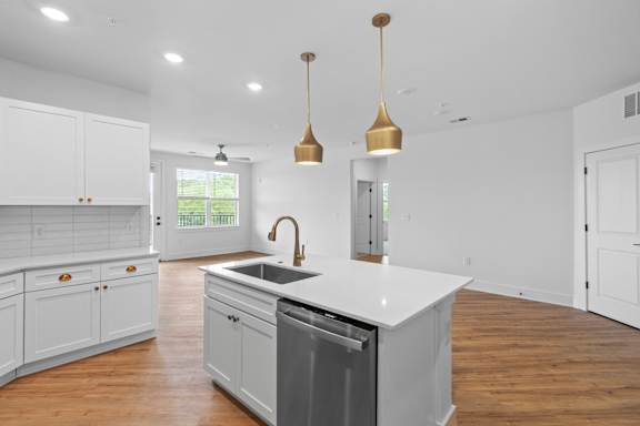 A modern kitchen with white cabinets and a large island.