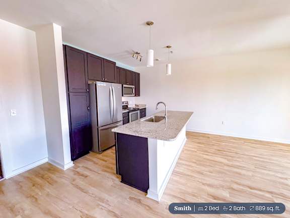 A kitchen with a sink and a refrigerator.