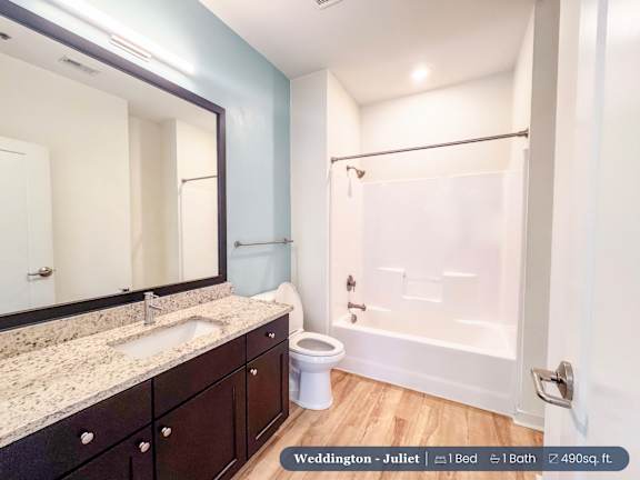 A bathroom with a sink, toilet, and bathtub.