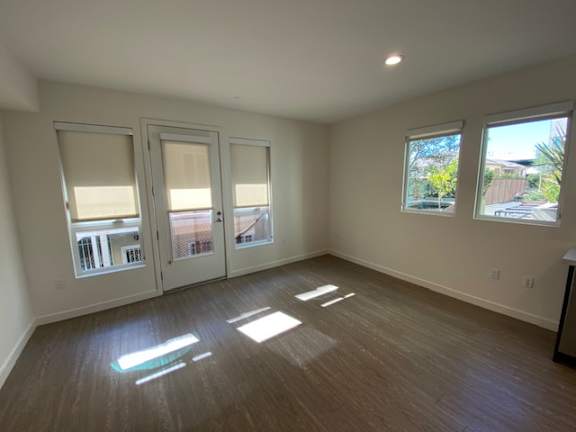 Living room with wood flooring and windows. at unit 203, 739 South Ogden Drive.