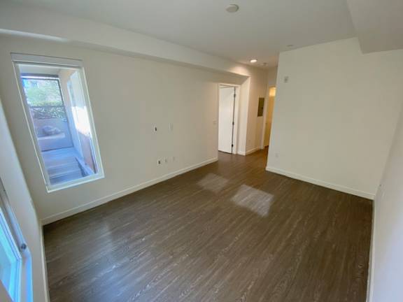 Bedroom with wood flooring and windows at unit 203, 739 South Ogden Drive.