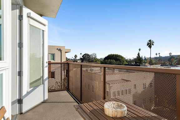 Balcony with a brown railing.