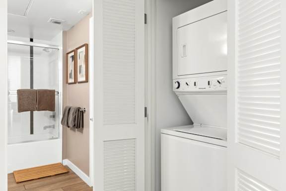 A white washing machine in a laundry area.