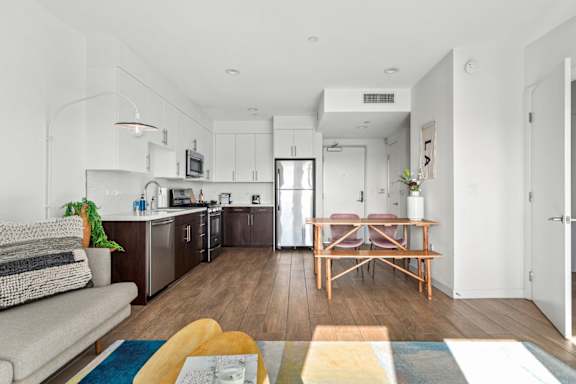Modern kitchen with a dining table/chairs and a view of the kitchen.