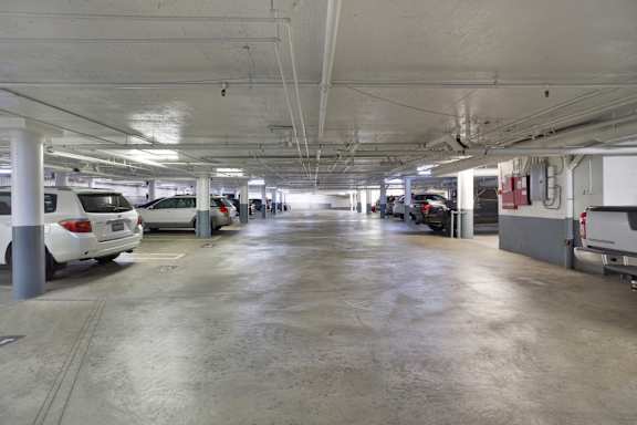 A parking garage with several cars parked. at The Hilgard, Los Angeles, CA, 90024