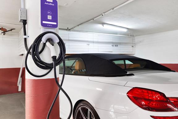 A vehicle being charged at a charging station.