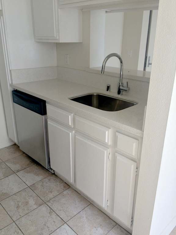 A kitchen with a sink and a dishwasher.