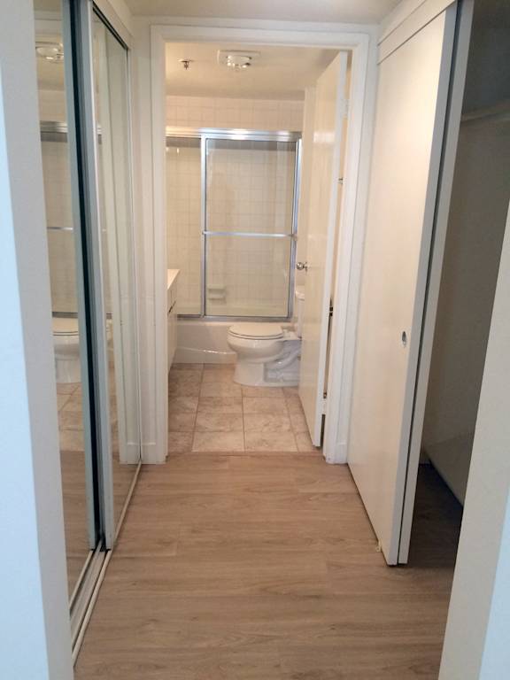 A bathroom with a toilet, sink, and shower.