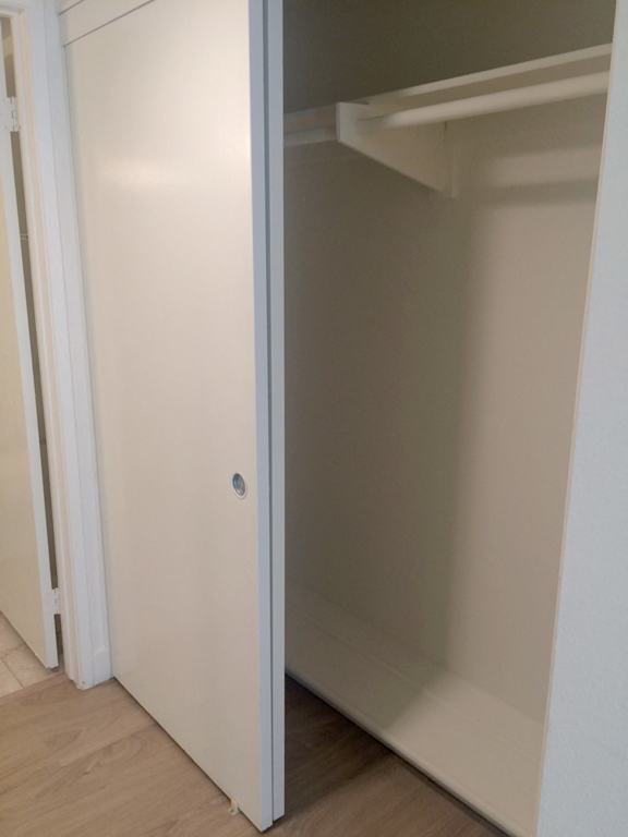 A white door is open to a white interior.