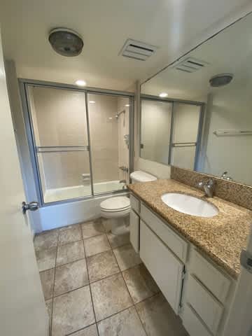 A bathroom with a sink, toilet and shower.