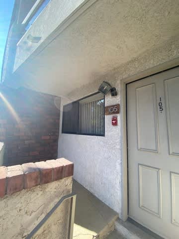 A white door with a number 105 on it.
