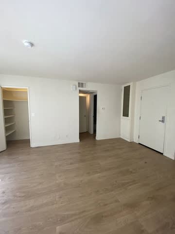 A room with wooden floors and white walls.