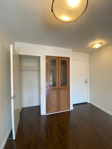 A room with a wooden floor and a wooden door.