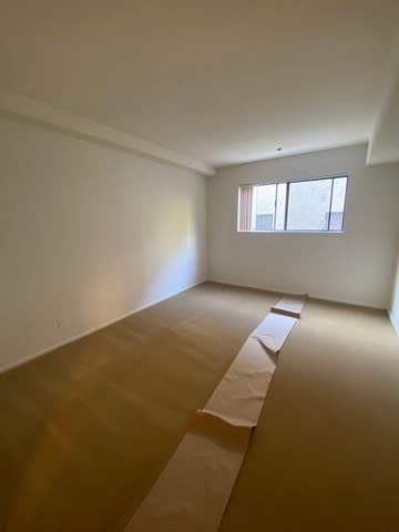 A room with a window and a long piece of paper on the floor.