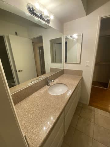 A bathroom with a sink and mirror.