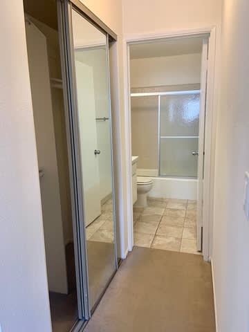 A bathroom with a toilet, sink, and shower.