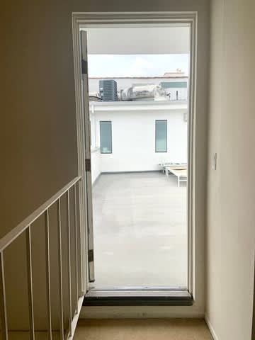 A view from inside a room looking out through a glass door.
