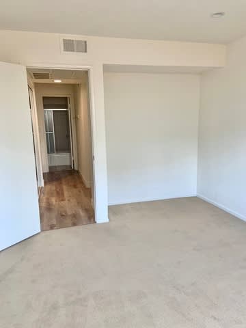 A room with a doorway leading to another room.