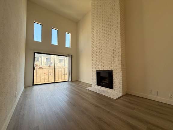 A room with a fireplace and sliding glass doors.